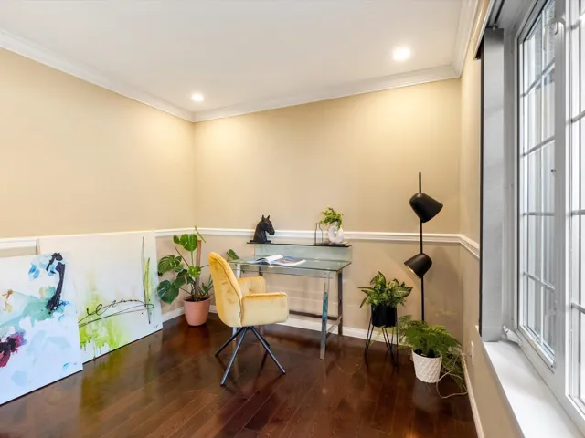 Office space with a healthy amount of sunlight, wood finished floors, and crown molding