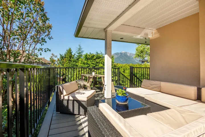 Exterior space with a mountain view, a balcony, and outdoor lounge area