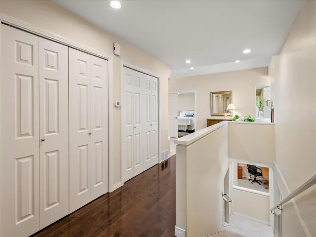 Corridor featuring recessed lighting, an upstairs landing, and dark wood-style floors