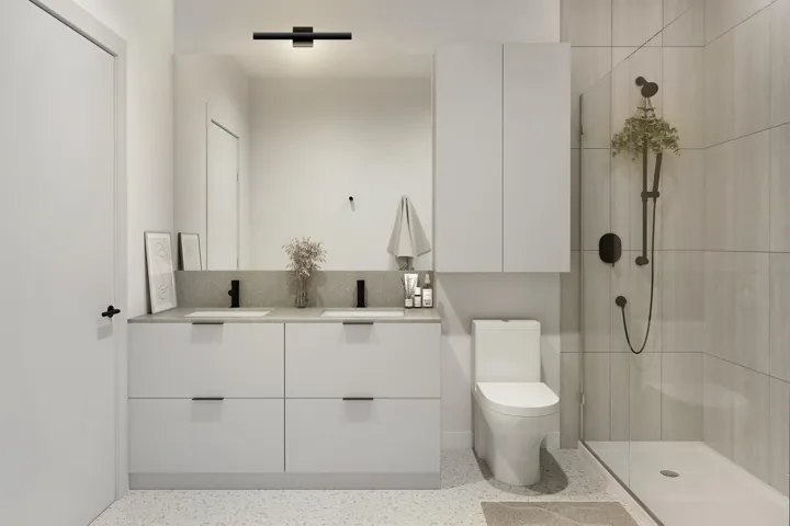 Contemporary bathroom featuring a dual vanity with undermount sinks, a large frameless mirror, an enclosed shower with a matte black fixture, and light-toned tile flooring