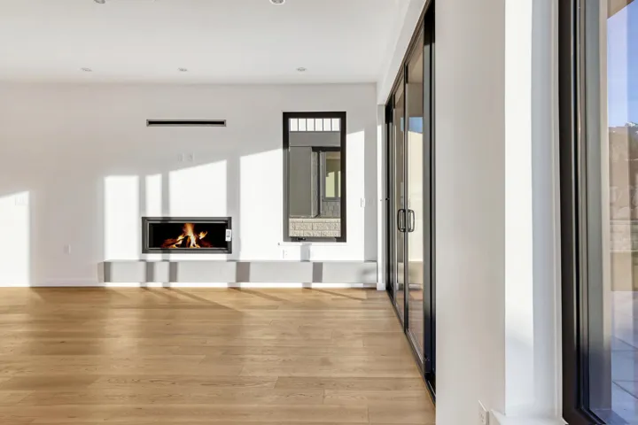 Unfurnished living room featuring recessed lighting, a lit fireplace, and light wood finished floors