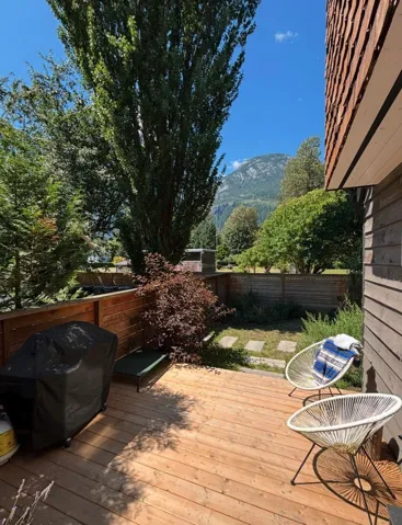 Deck featuring area for grilling, a fenced backyard, and a mountain view