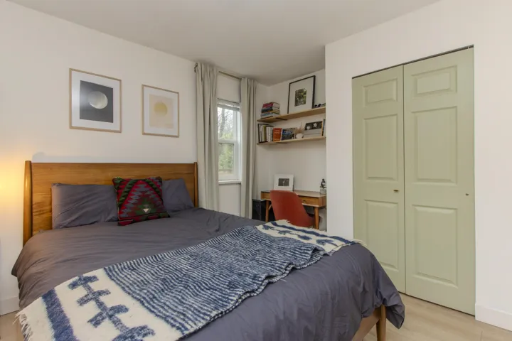 Bedroom featuring light wood finished floors and a closet