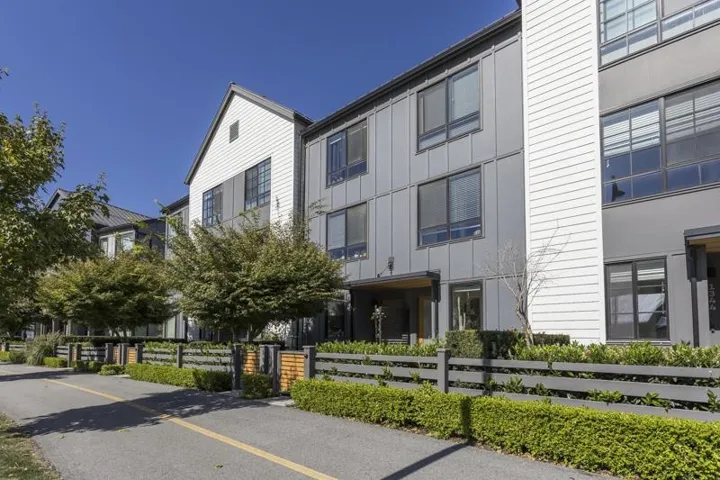 Modern facade featuring grey paneling and white horizontal siding