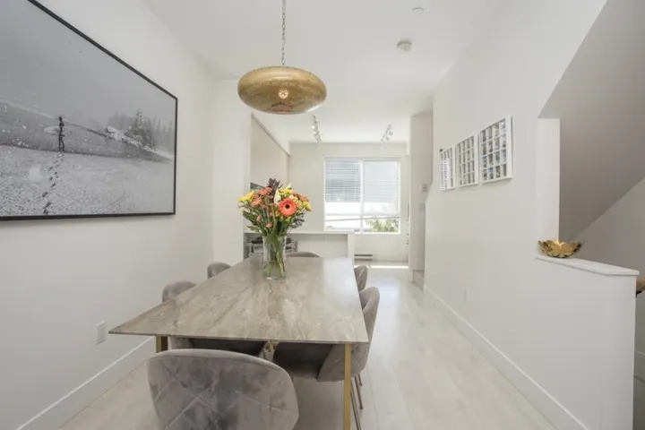 Recessed lighting, wood-finish flooring, and a contemporary pendant light fixture