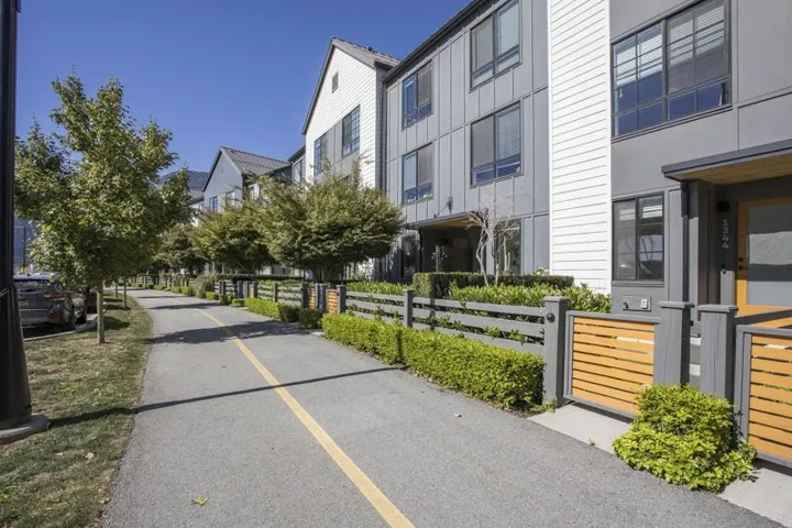 Modern exterior featuring gray siding, white horizontal siding accents, and dark-framed windows