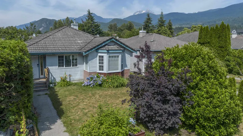Light blue siding with a grey tile roof and a bay window