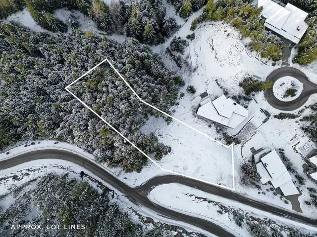 Aerial view of property and surrounding area with property parcel outlined