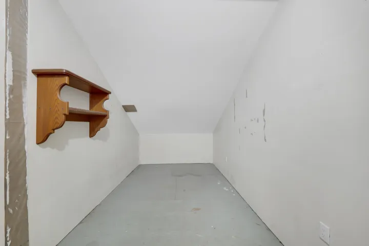Additional living space featuring lofted ceiling