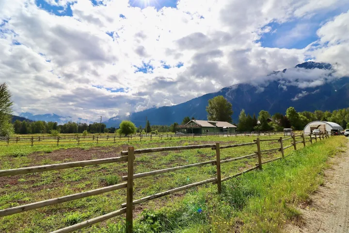 Expansive fenced grounds with a distant mountain backdrop