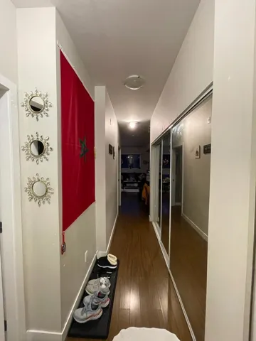 Hall with wood finished floors and baseboards