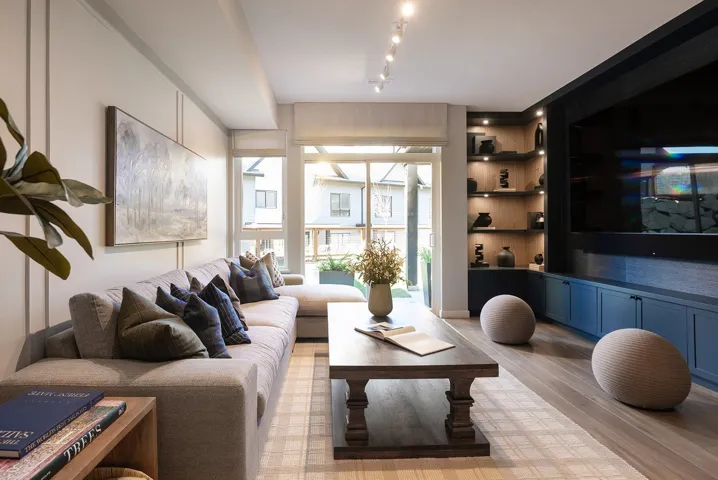 Living room with built in shelves and light wood-style floors