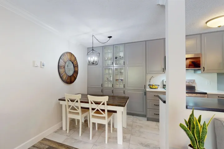 Dining area with a chandelier and baseboards