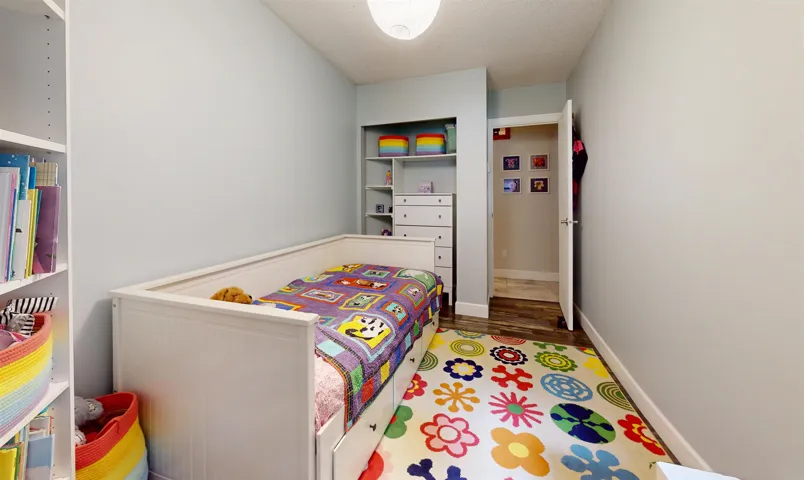 Bedroom featuring wood finished floors and baseboards