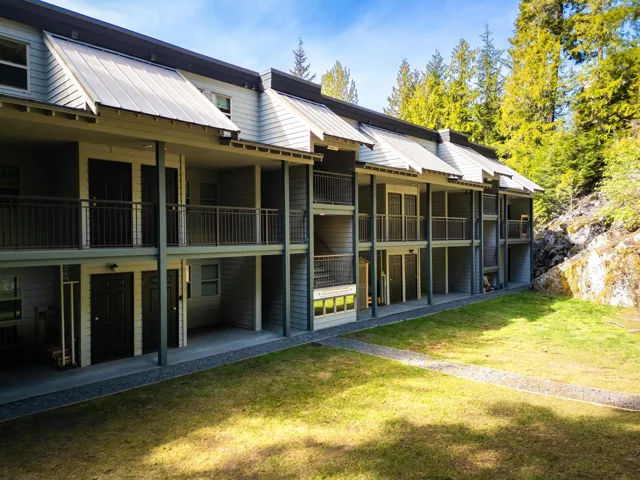 Rear view of house with a lawn and metal roof