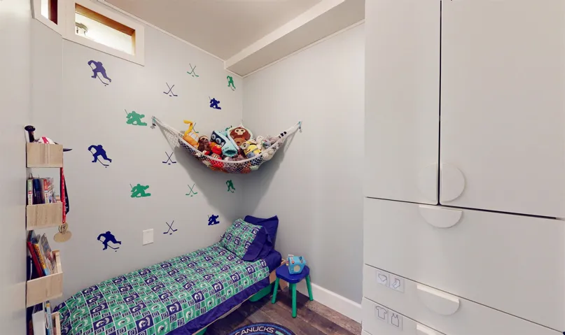 Bedroom with wood finished floors and baseboards