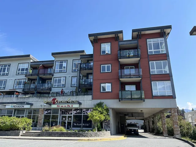 View of apartment building / complex with a carport
