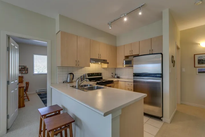 Kitchen featuring appliances with stainless steel finishes, light brown cabinets