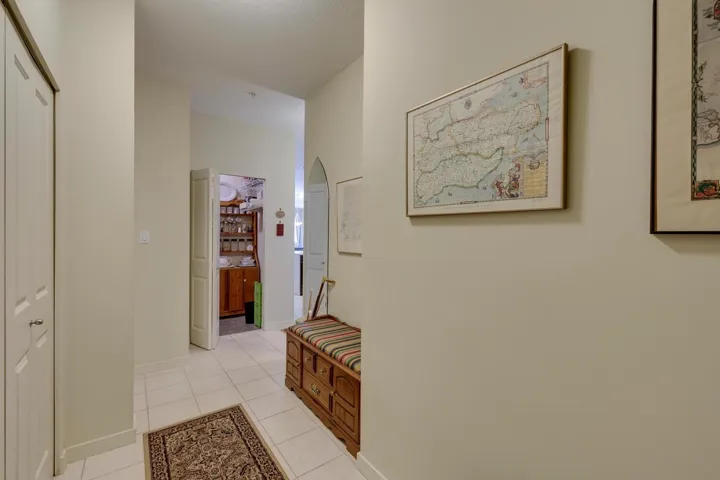 Hall featuring light tile patterned flooring and arched walkways
