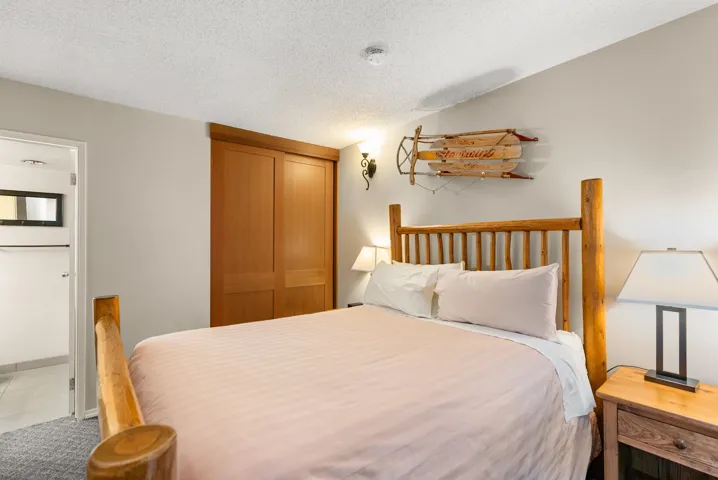Bedroom with dark colored carpet and a textured ceiling