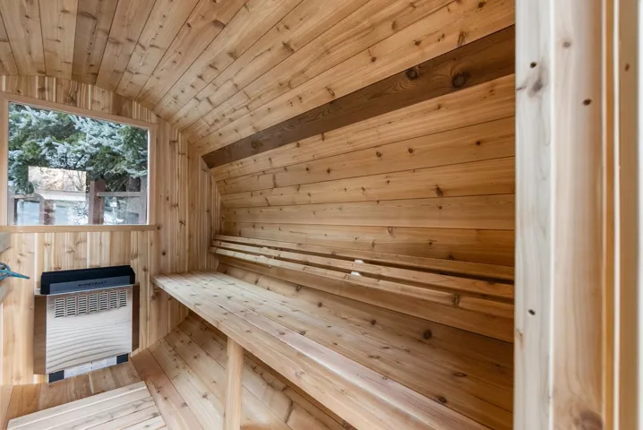 Sauna with wood walls and wood ceiling