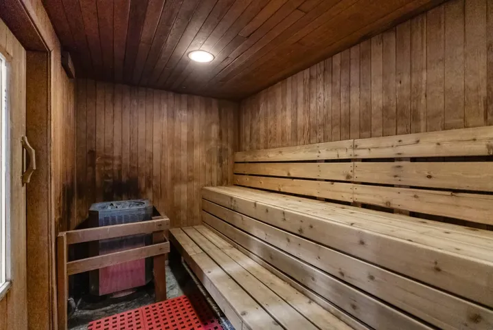 View of community featuring a tennis court and a gate