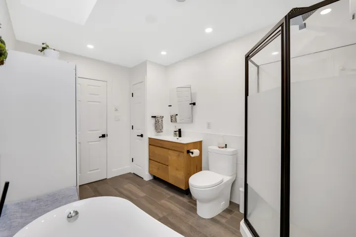Rich wood-finish flooring complements the neutral wall tones