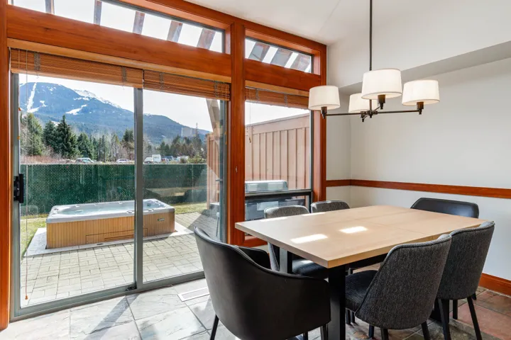 Dining area featuring a contemporary chandelier and wood-frame sliding glass doors