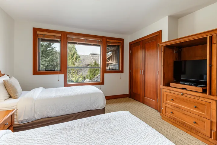 Hardwood-framed windows with exterior tree views