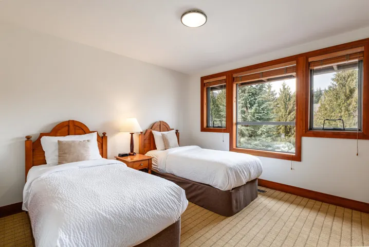Room featuring three large windows with wood-finish trim, offering abundant natural light