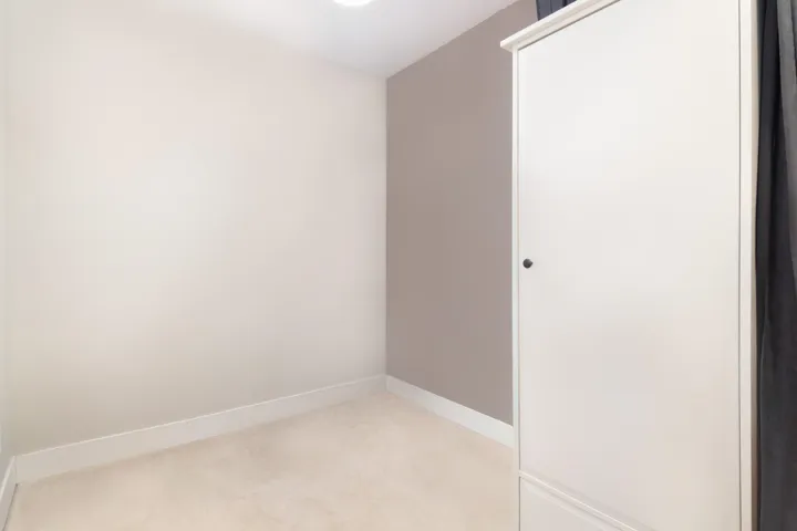 Empty room with baseboards and light colored carpet