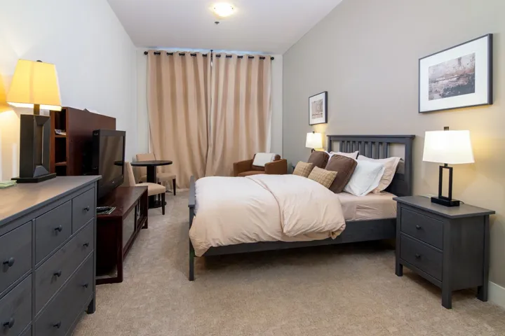 Bedroom with light colored carpet
