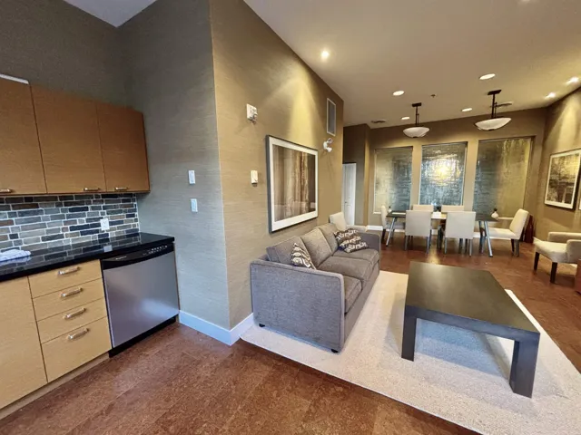 Kitchen featuring visible vents, baseboards, stainless steel dishwasher, tasteful backsplash, and dark countertops