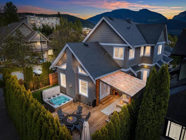 Rooftop deck featuring artificial turf, a built-in fire pit, and glass panel railing