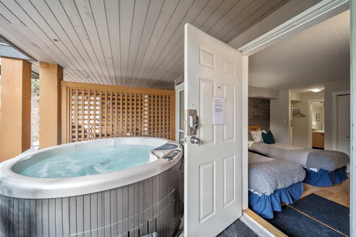 Misc room featuring a hot tub, wood finished floors, and wood ceiling