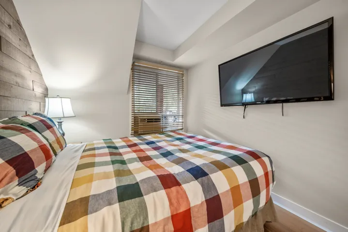 Bedroom with wood finished floors and baseboards