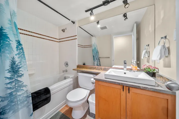 Full bathroom featuring shower / tub combo, toilet, and vanity