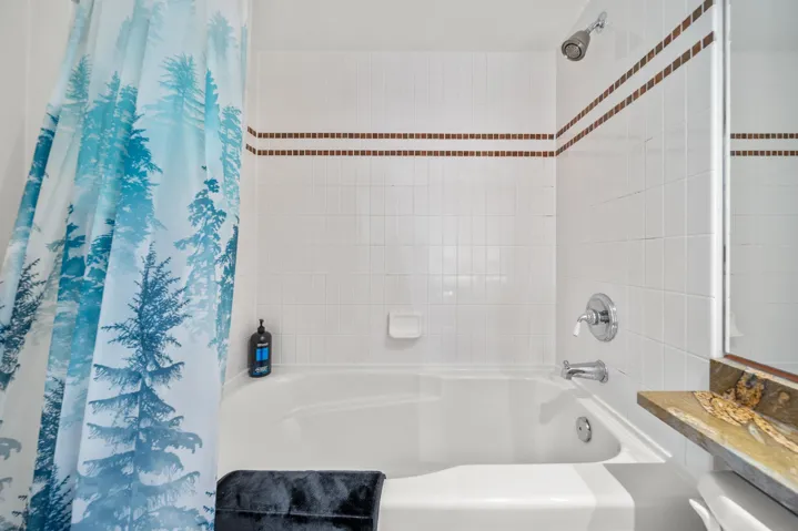 Full bath featuring shower / bath combo