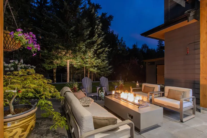 Patio at twilight with an outdoor living space with a fire pit and a patio area