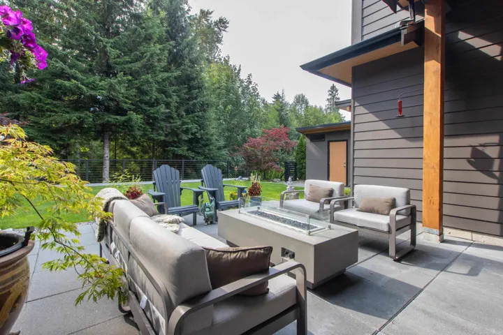 View of patio featuring an outdoor living space with a fire pit and view of scattered trees