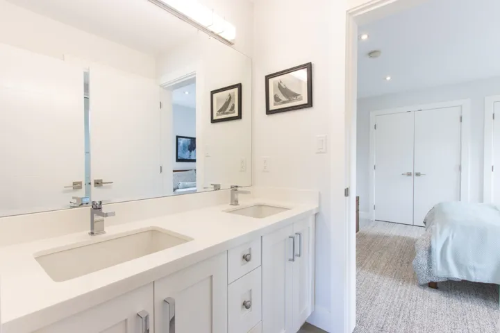Bedroom featuring multiple closets, light carpet, and recessed lighting