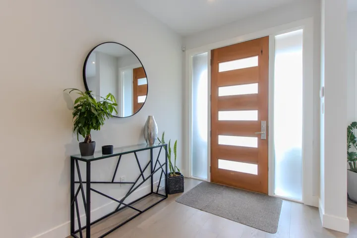 Kitchen featuring open floor plan, white cabinetry, a breakfast bar, decorative backsplash, and recessed lighting