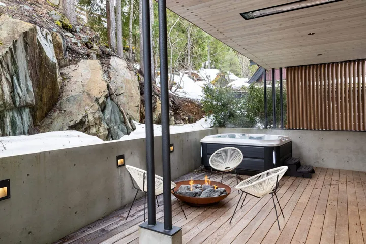 Deck with a fire pit and a hot tub