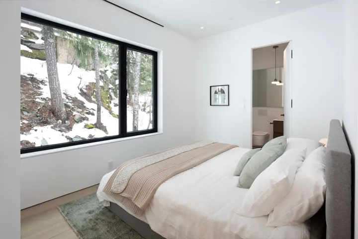Bedroom with ensuite bath, wood finished floors, and recessed lighting
