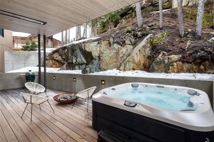 Wooden terrace featuring a hot tub