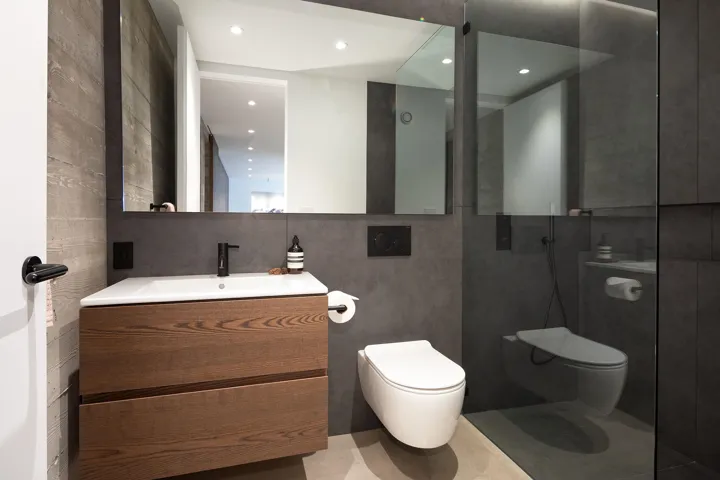 Full bath with walk in shower, vanity, tile walls, and recessed lighting