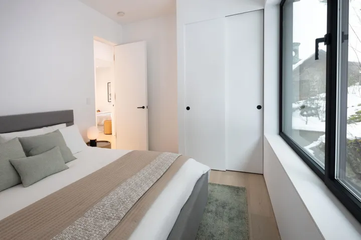 Bedroom with wood finished floors and a closet