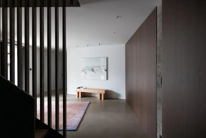 Corridor with finished concrete floors and wood walls
