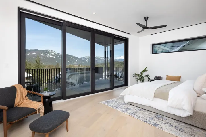 Bedroom with access to exterior, a mountain view, light wood-type flooring, and ceiling fan