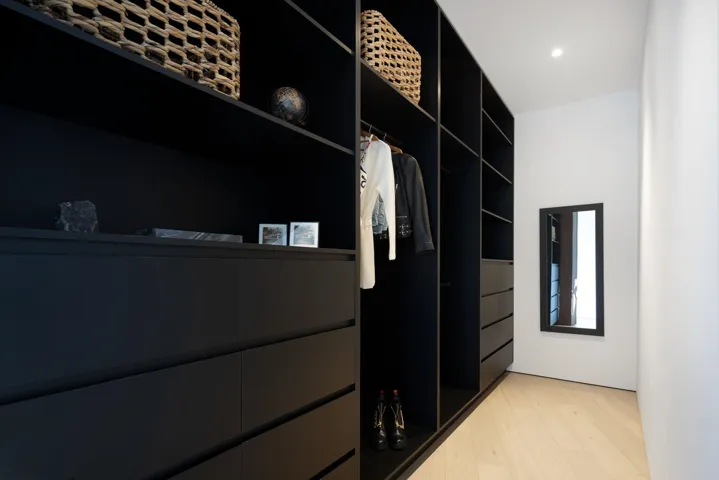 Walk in closet with light wood-style floors